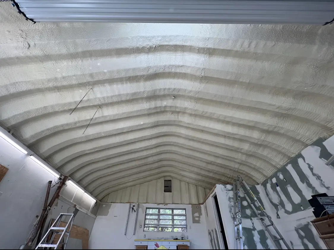 Spray polyurethane foam applied to the underside of a metal roof deck in Edwards